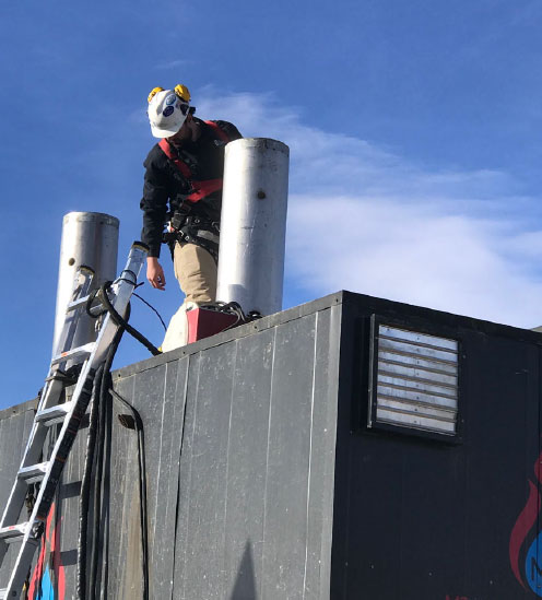 Photo of an engineer on top of the Strongbox Solutions Mobile Flash Vaporization System